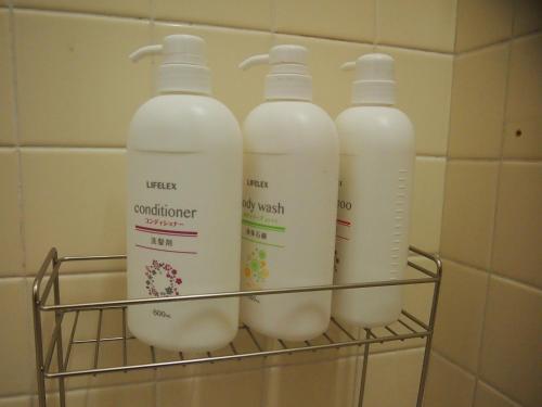 four bottles of milk in a rack in a refrigerator at ICHIE Second Location in Tanabe