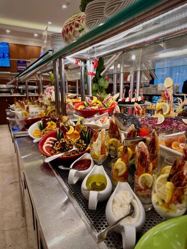 a buffet line with many different types of food at Nozol Royal Inn Hotel in Al Madinah