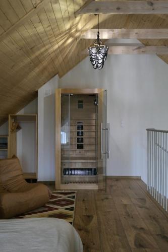 a living room with a bed and a fireplace at Harmonia Horyniec in Horyniec Zdrój