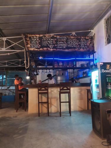 a bar in a restaurant with a menu on the wall at Ultimate voyage in Toliara