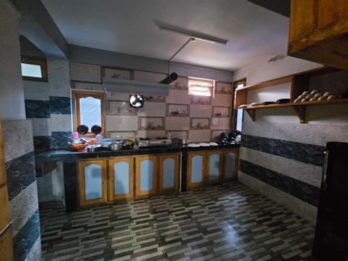 a large kitchen with wooden counter tops in a room at Amaze PY Homestay in Tawang