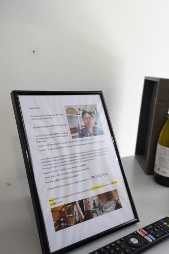 a picture of a bottle of wine next to a remote control at Zen Escape Guest House " Location 2" - Zen Garden Tiny Home, Nooky Studio, Chillax Rest in Brisbane