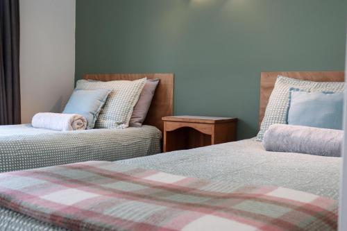 a room with two beds and a couch at Kanuka Ridge Lodge in Marahau