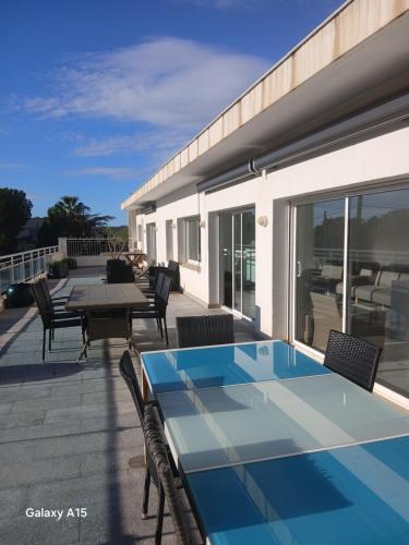 a patio with a table and chairs on a deck at Appartement Almadrava Roses in Roses