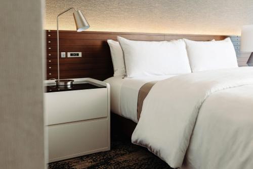 a bedroom with a bed and a nightstand next to a bed at The Westin San Diego Gaslamp Quarter in San Diego