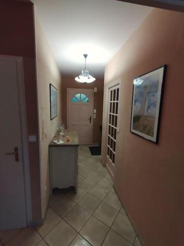 a hallway of a home with a sink and a door at parent aise in Azé