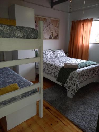 a bedroom with two bunk beds and a window at 95 on 15th in East London