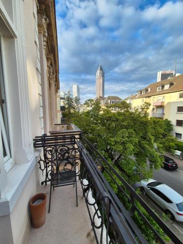 a balcony with chairs and a view of a city at Hotel Beethoven in Frankfurt/Main