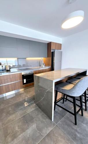 a kitchen with a table and two chairs in it at Exclusive 2 Bedroom Apartment in Grand Sapphire Resort Iskele in Iskele