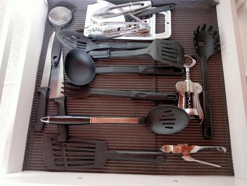 a drawer full of kitchen utensils in a box at Cosy n Central Rotorua 2BR Entire House & Studio -summer only in Rotorua