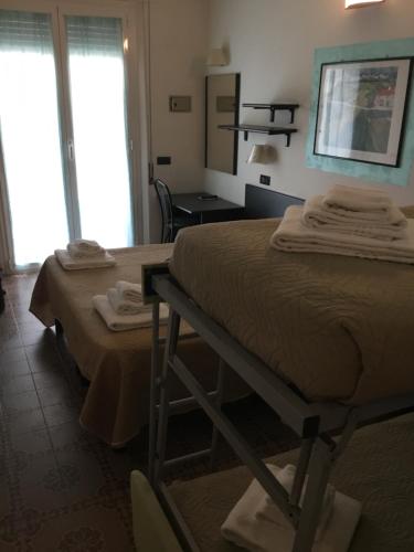 Cama o camas de una habitación en SI Rimini Hotel
