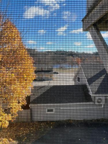 a screened in window with a view of the ocean at Hallowell Rooming House in Hallowell