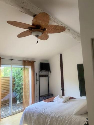 a bedroom with a ceiling fan and a bed at Studio 2 à 4 pers in Grans