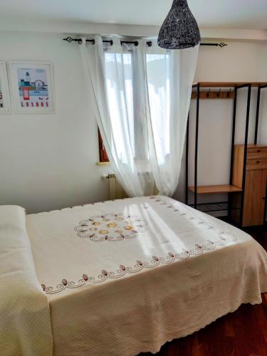 a bedroom with a bed with a white curtain at Al serro in Galati Mamertino