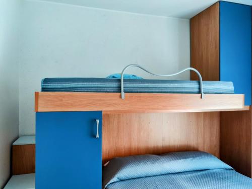 a bunk bed with two blue bunk beds at Al serro in Galati Mamertino