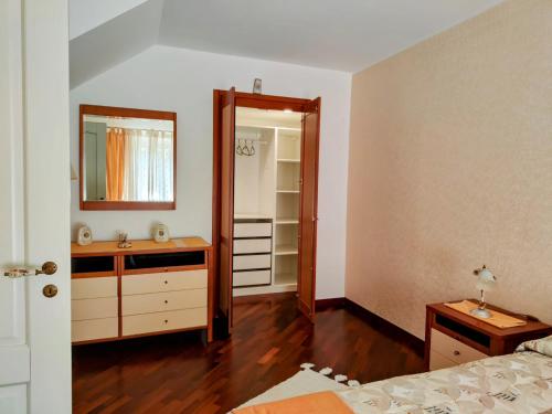 a bedroom with a bed and a mirror and a dresser at Al serro in Galati Mamertino