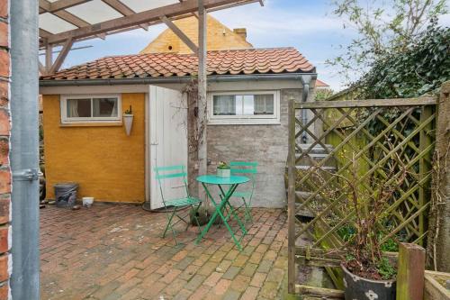 a patio with a table in front of a house at Lovely Holiday Apartment In Rønne in Rønne
