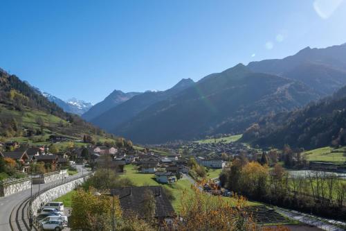 a town in a valley with mountains in the background at Apartment Soleil in Le Châble