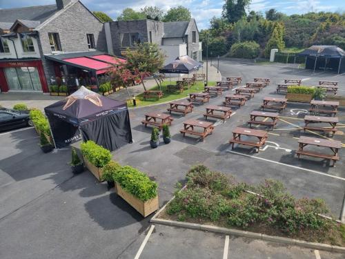 an aerial view of a parking lot with wooden benches at Kettles Country House Hotel in Swords