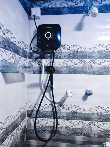 a camera on a wall in a bathroom at Breeze Guest House in Trincomalee