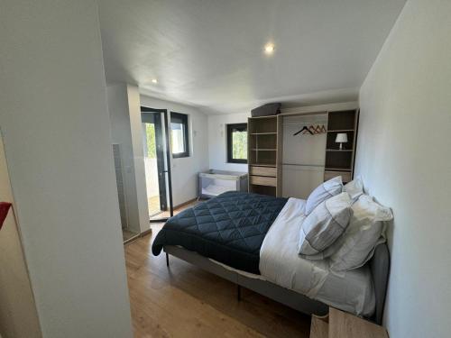 a bedroom with a bed with a blue comforter at villa bord de mer 400 M de la plage in Labenne