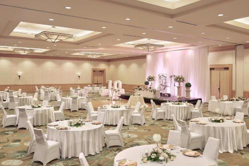 a banquet hall with white tables and white chairs at The Westin Bayshore, Vancouver in Vancouver