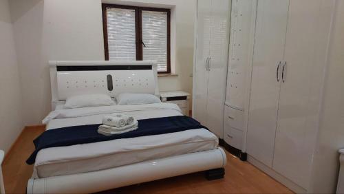 a bedroom with a bed with a towel on it at Mon Ami Sevan in Tsovazard