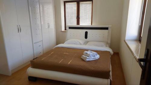 a small bedroom with a bed with towels on it at Mon Ami Sevan in Tsovazard