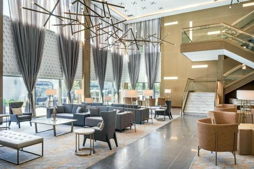 a lobby with couches and chairs and tables at Delta Hotels by Marriott Ontario Airport in Ontario