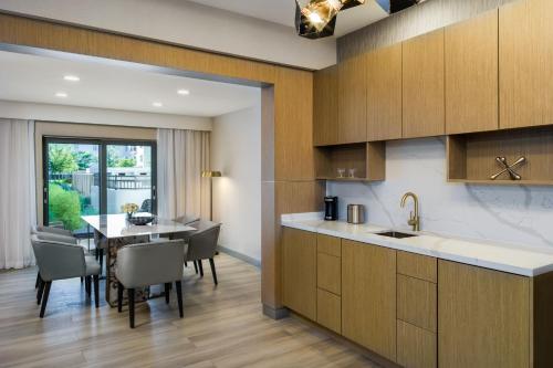 a kitchen and dining room with a table and chairs at Delta Hotels by Marriott Ontario Airport in Ontario