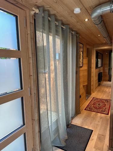 a hallway with curtains in a room with a window at Sous Les Pins in Labaroche
