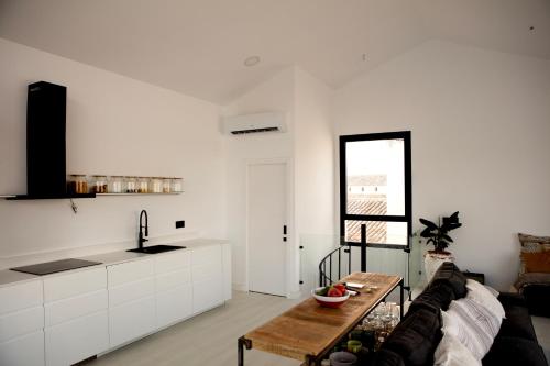 a living room with a couch and a table at PoolHouse in the Historic Center in Baena