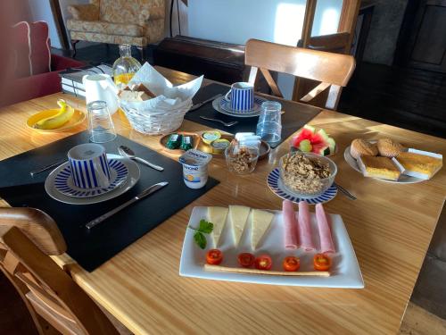 a wooden table with a plate of food on it at Casa Rural Basiver - Habitación Pico San Carlos in Armaño
