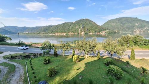a car driving down a road next to a lake at Dijanin Konak in Zvornik