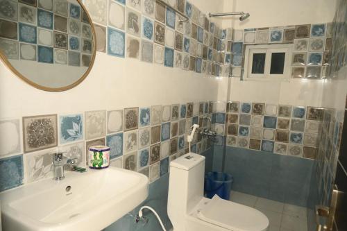 a bathroom with a toilet and a sink and a mirror at shangrila stay in Bodh Gaya
