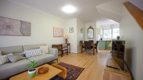 a living room with a couch and a table at Best Location Leederville Townhouse in Perth