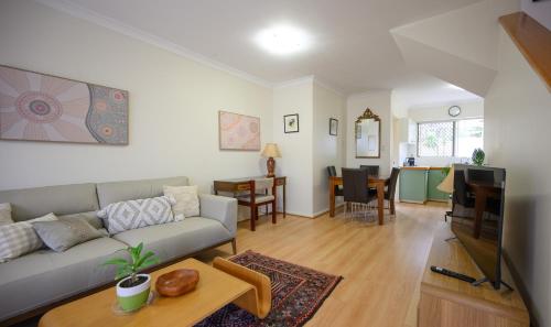 a living room with a couch and a table at Best Location Leederville Townhouse in Perth