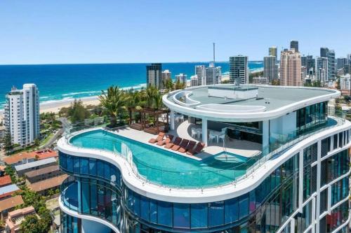 a building with a swimming pool and the beach at Coastal Escape in Broadbeach in Gold Coast