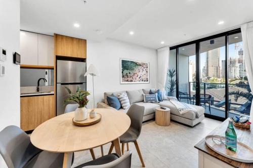 a living room with a couch and a table at Coastal Escape in Broadbeach in Gold Coast