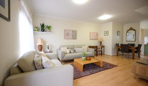 a living room with a couch and a table at Best Location Leederville Townhouse in Perth