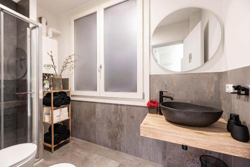 a bathroom with a black sink and a mirror at Ca' San Marco - Residenza di Lusso a Due Passi dalla Basilica in Vicenza