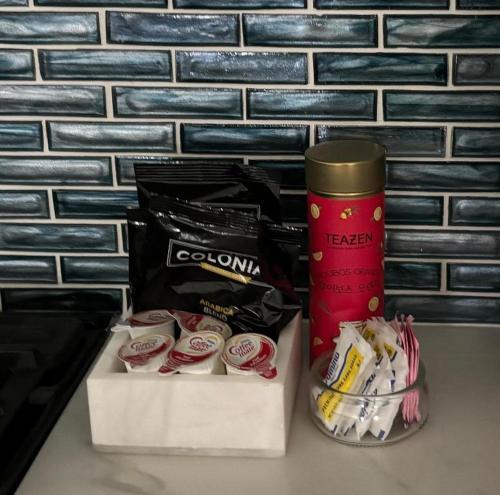 a table with a cup of coffee and some snacks at Luxury Designer Villa by the Beach Bright Beautiful Brand New in Galveston