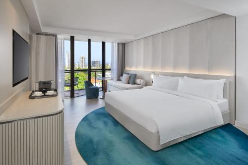 a bedroom with a large white bed and a living room at JW Marriott Gold Coast Resort & Spa in Gold Coast