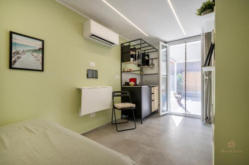 a bedroom with a bed and a desk with a chair at Downtown Apartments Dolci Coccole The Terrace in Bari