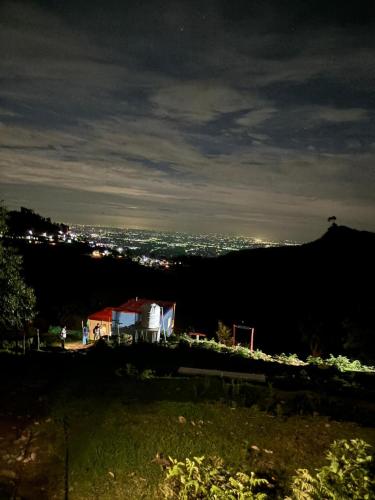 a view of a city from a hill at night at Kookal Valley in Kodaikānāl