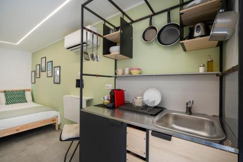 a kitchen with a sink and a bed in a room at Downtown Apartments Dolci Coccole The Terrace in Bari