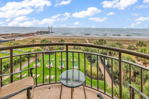 a balcony with a table and a view of the ocean at Meridian Plaza 404 in Myrtle Beach