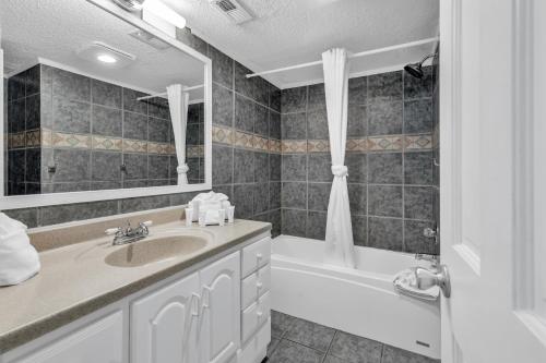 a bathroom with a sink and a bath tub at Spectacular Oceanview Condos in Myrtle Beach