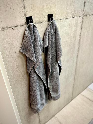 a pair of gray gloves hanging on a wall at Suburban Loft in Bochum