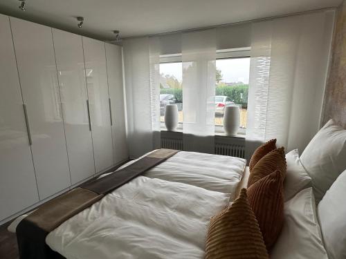 a bedroom with a large bed and a window at Ferienwohnung Forstblick in Kranenburg